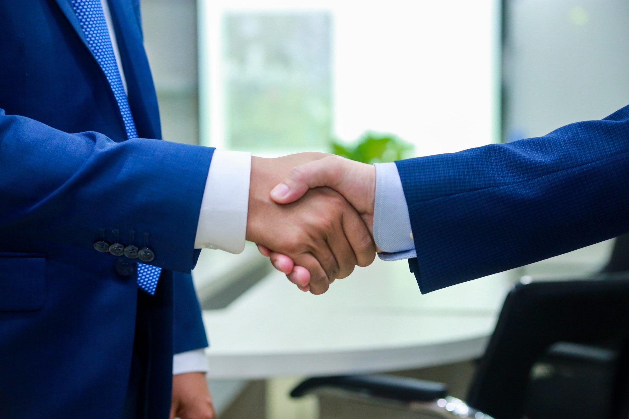 To deal withBusiness people shake their hand before negotiation